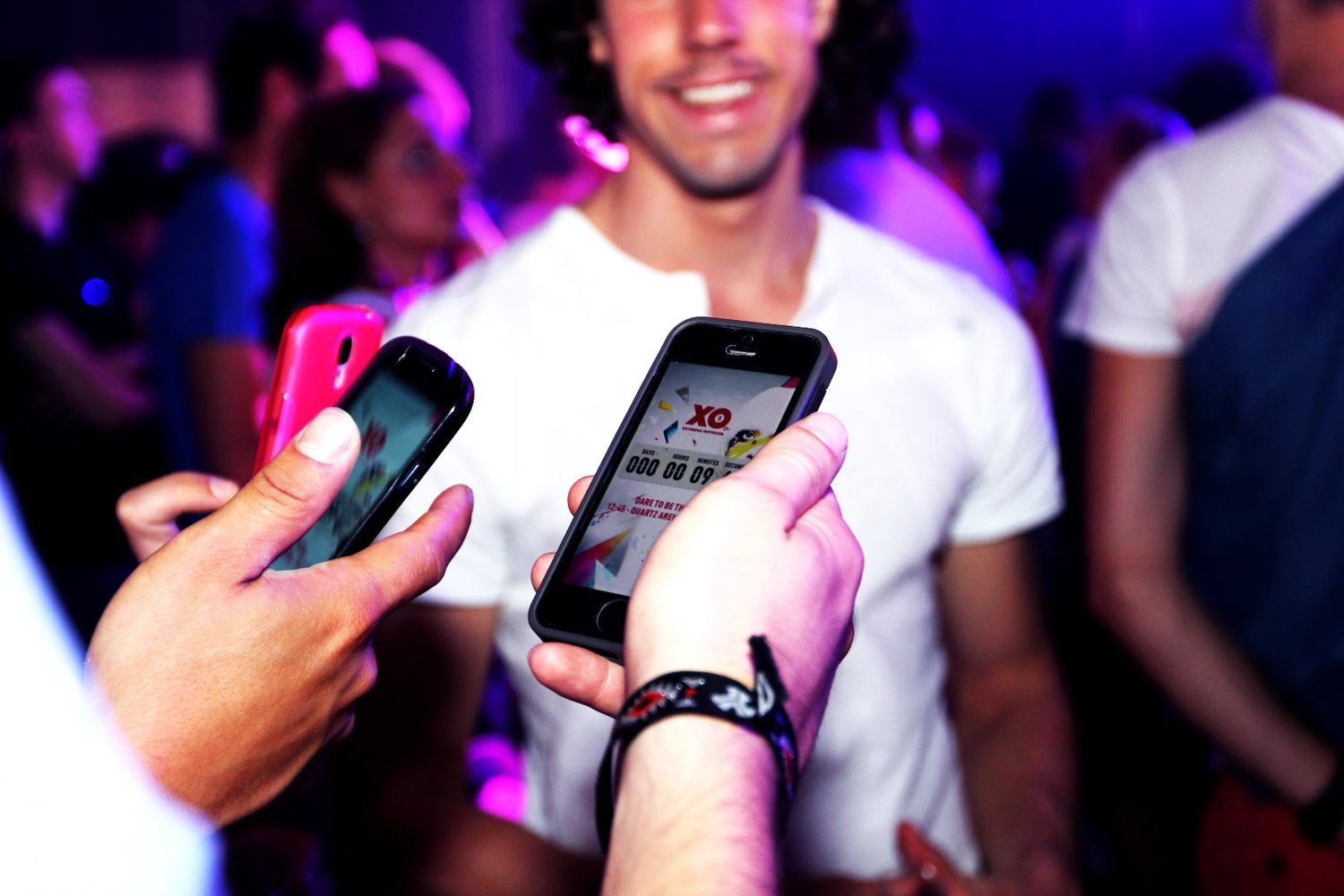 Crowd at the XO festival holding up glowing phones
