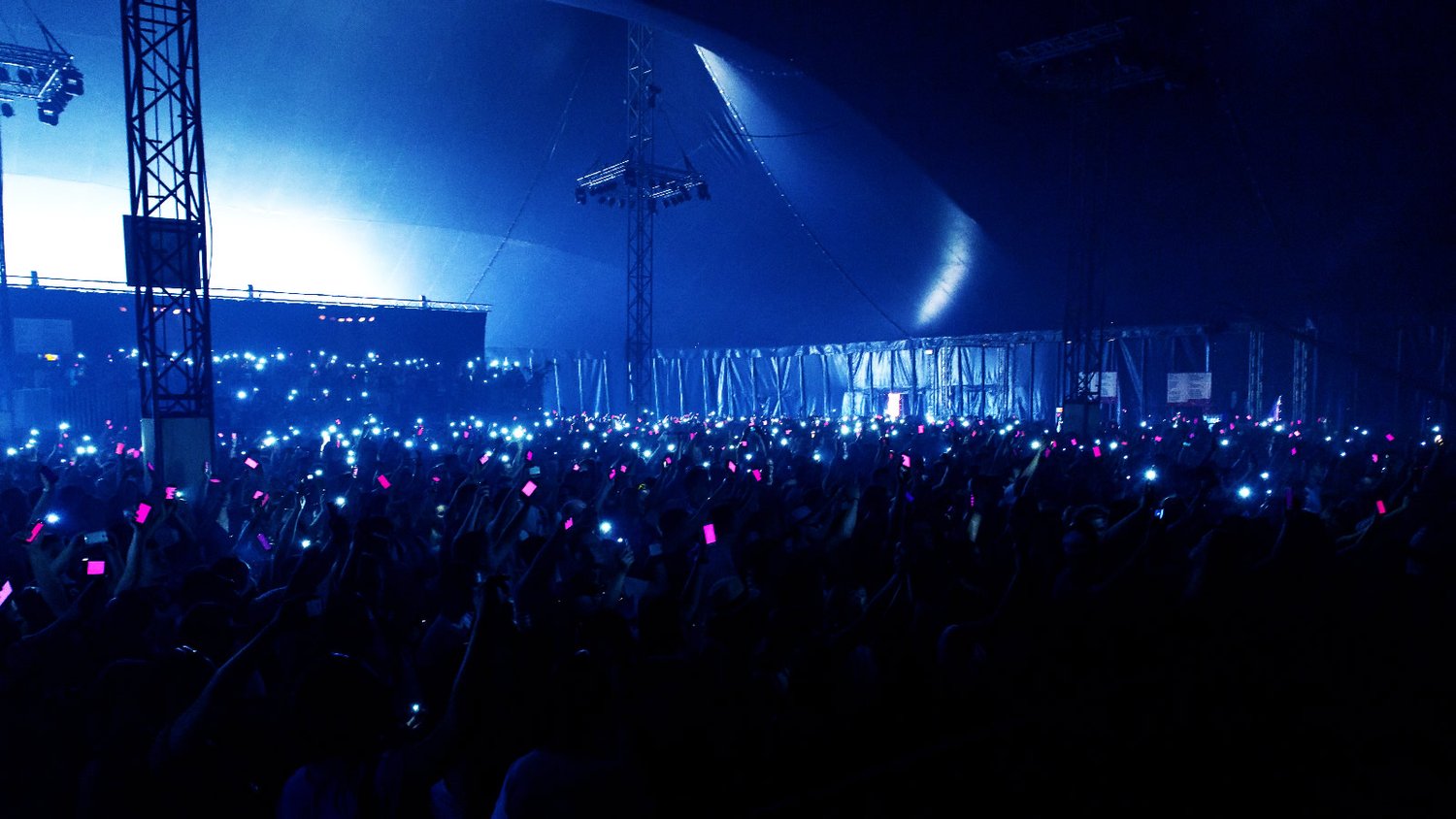 Phone flashlights blinking on the beat of the music